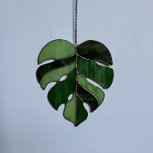 Glas in lood hanger: een monstera blad gemaakt van 3 verschillende groen tinten tiffany glas.