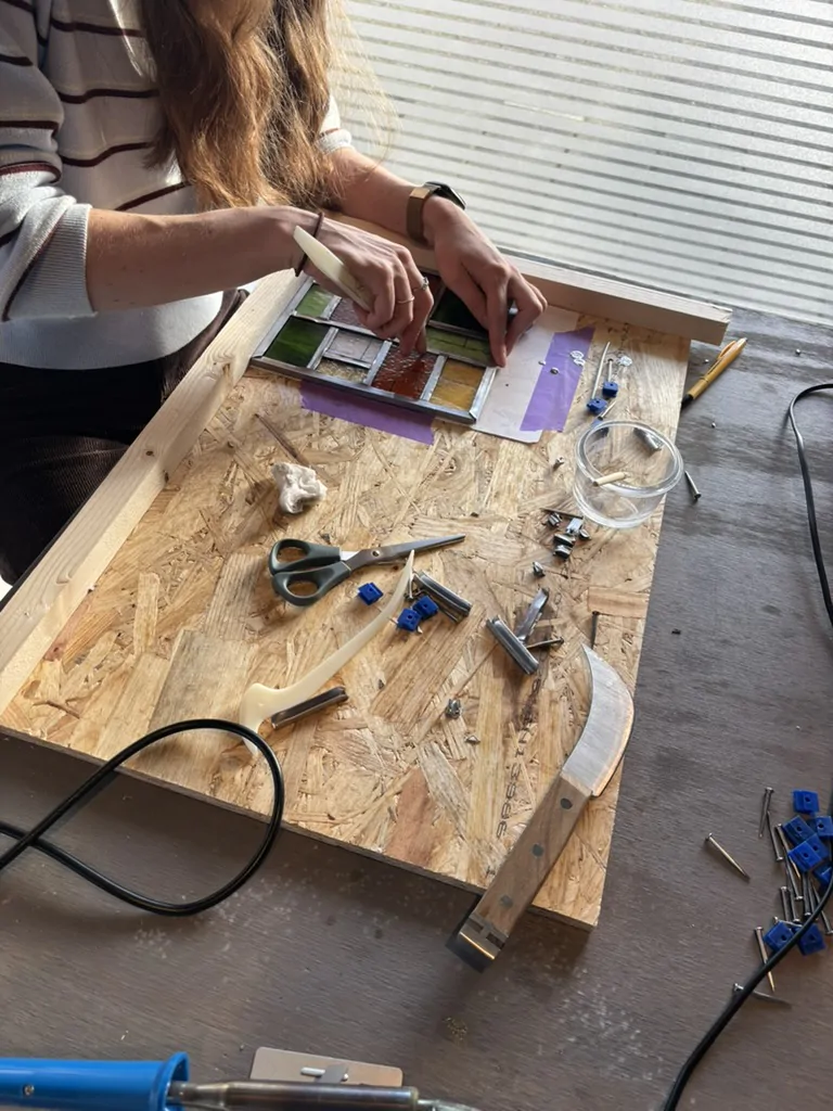 Cursist aan het werk aan een glas-in-lood raampje